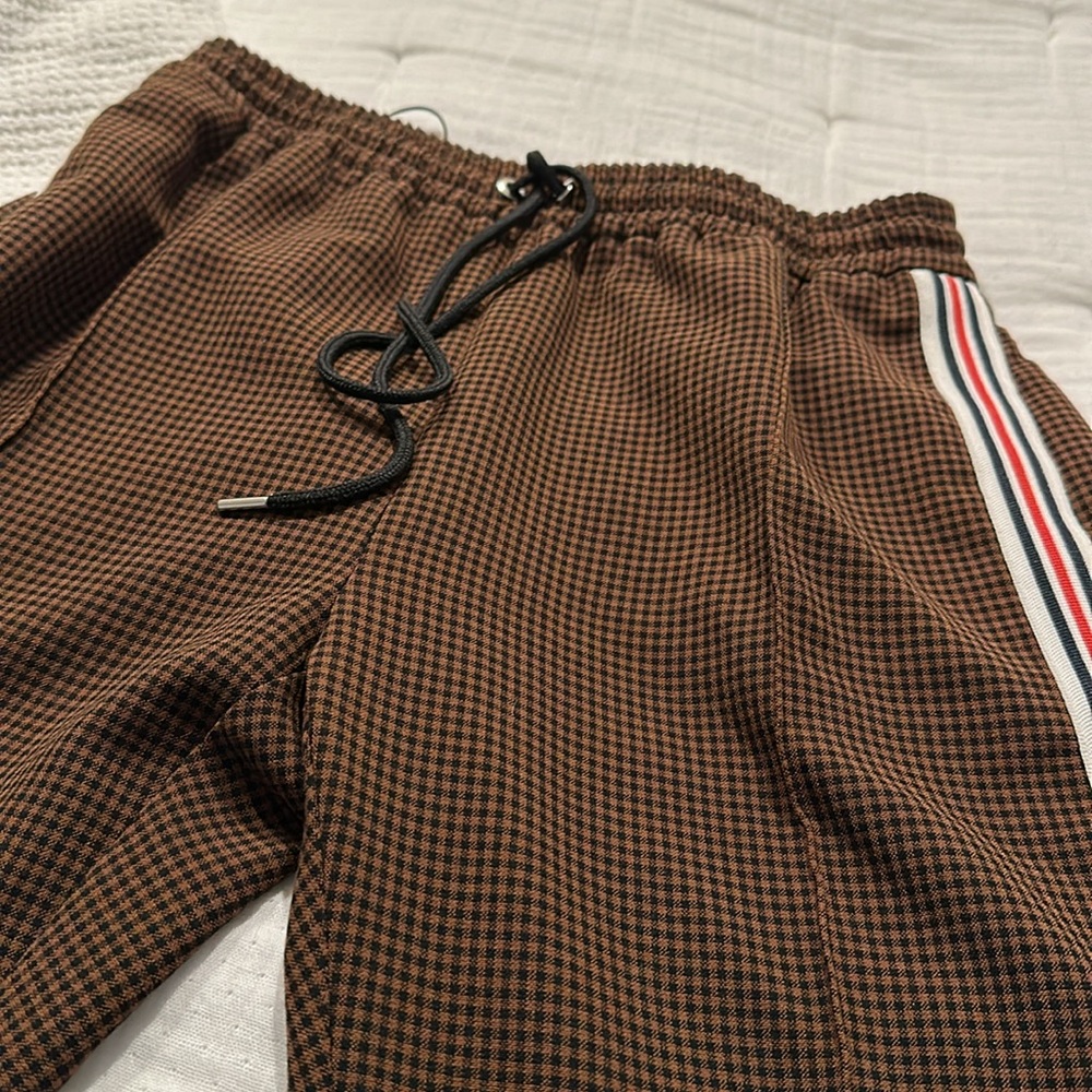 Brown and black checkered pants with sporty stripe